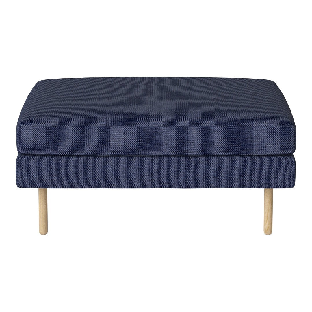 Navy blue upholstered ottoman with a textured fabric and natural wooden legs, adding a modern touch to any space.