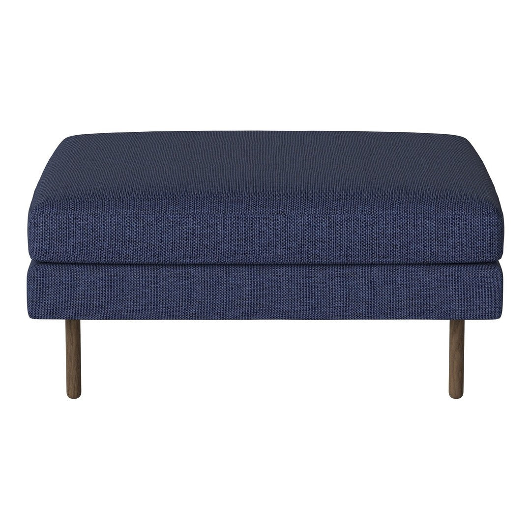 Navy blue upholstered ottoman with a textured pattern and minimalistic wooden legs. Perfect for modern decor.