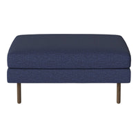 Navy blue upholstered ottoman with a textured pattern and minimalistic wooden legs. Perfect for modern decor.