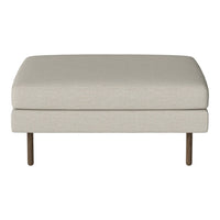 Beige upholstered ottoman with smooth texture and minimalist design, featuring wooden legs for a modern touch.
