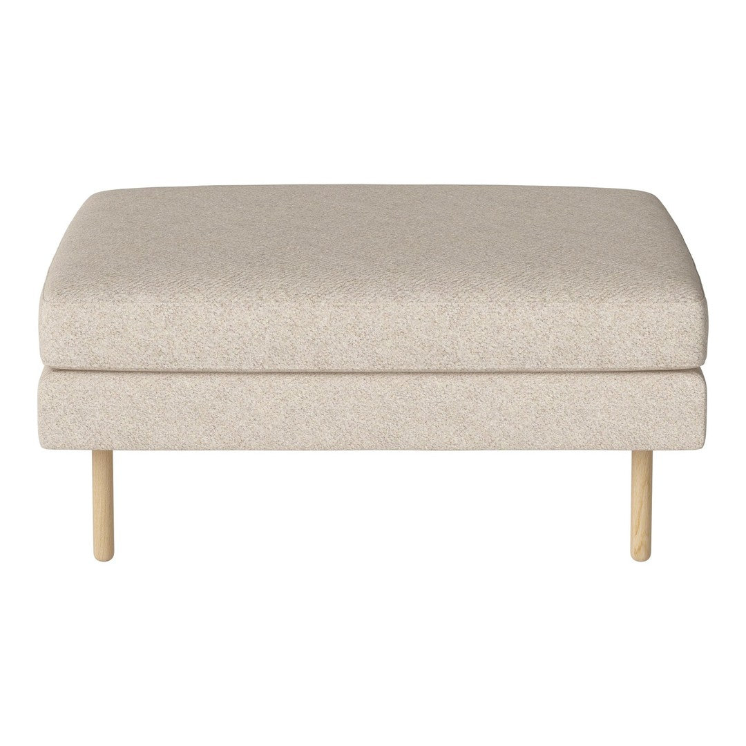 Beige upholstered ottoman with a smooth texture and light wood legs, ideal for modern decor.