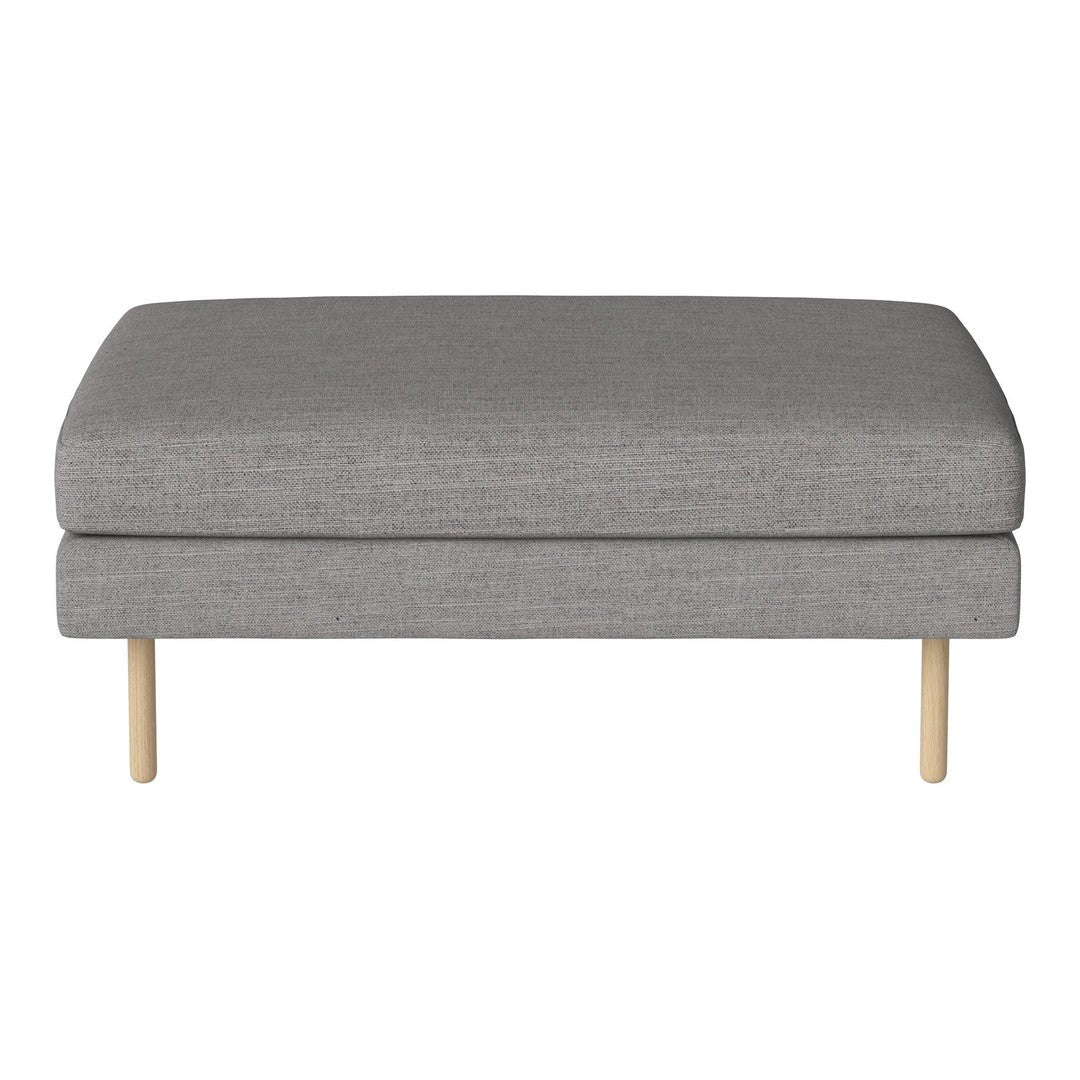 Gray upholstered ottoman with a smooth texture and natural wood legs. Minimalist design for modern interiors.