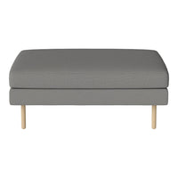 Gray upholstered ottoman with a subtle texture and light wooden legs, perfect for modern decor.