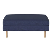 Navy blue upholstered ottoman with a textured pattern and natural wood legs. Ideal for modern living spaces.