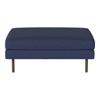 Navy blue upholstered ottoman with a textured weave pattern and sleek metal legs. Perfect for modern decor.