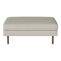 Light beige upholstered ottoman with a smooth texture and simple design, featuring slim wooden legs.