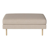 Beige upholstered ottoman with a smooth texture and minimalist design, resting on wooden legs. Perfect for modern decor.