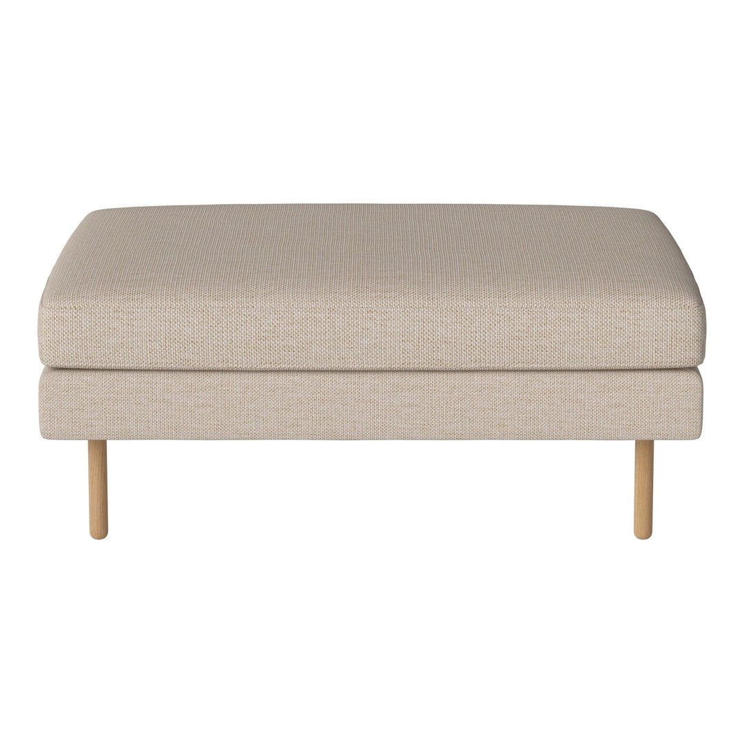 Beige upholstered ottoman with a simple, textured fabric and natural wood legs. Modern, minimalist design.