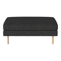 Dark gray upholstered ottoman with a subtle fabric texture and natural wood legs. Modern and minimalist design.