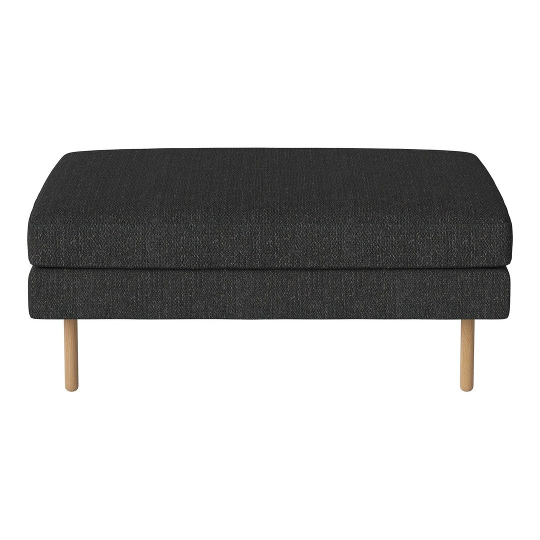 Dark gray fabric ottoman with a smooth texture and light wood legs, ideal for modern decor.