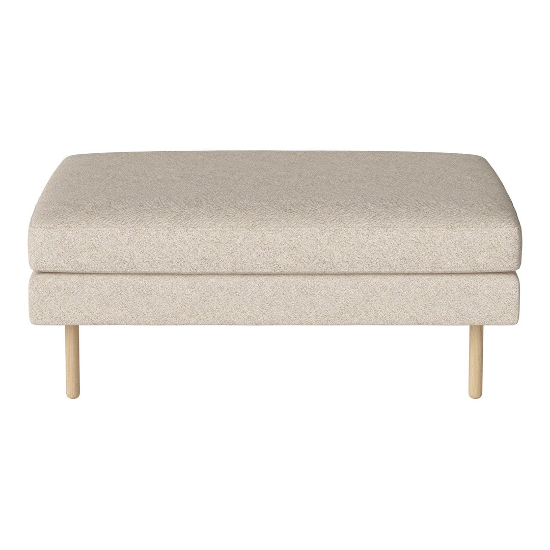 Beige upholstered ottoman with subtle texture and wooden legs, perfect for modern living spaces.