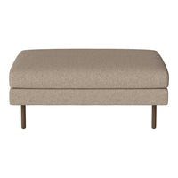 Tan upholstered ottoman with a smooth texture and minimalist design, featuring sturdy metal legs.