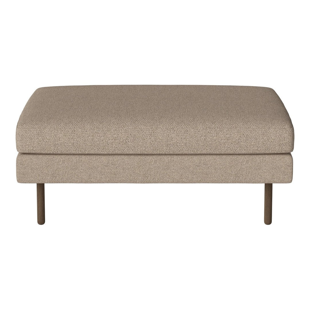 Beige upholstered ottoman with a smooth texture and minimalist design, featuring sleek metal legs.