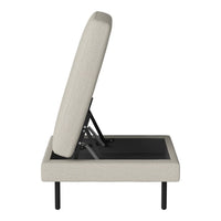 Light beige upholstery with a subtle texture and sleek black legs, featuring a modern, minimalist design.