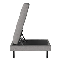 Gray upholstered adjustable bed frame with a sleek black base and minimalist design, highlighted by clean lines.