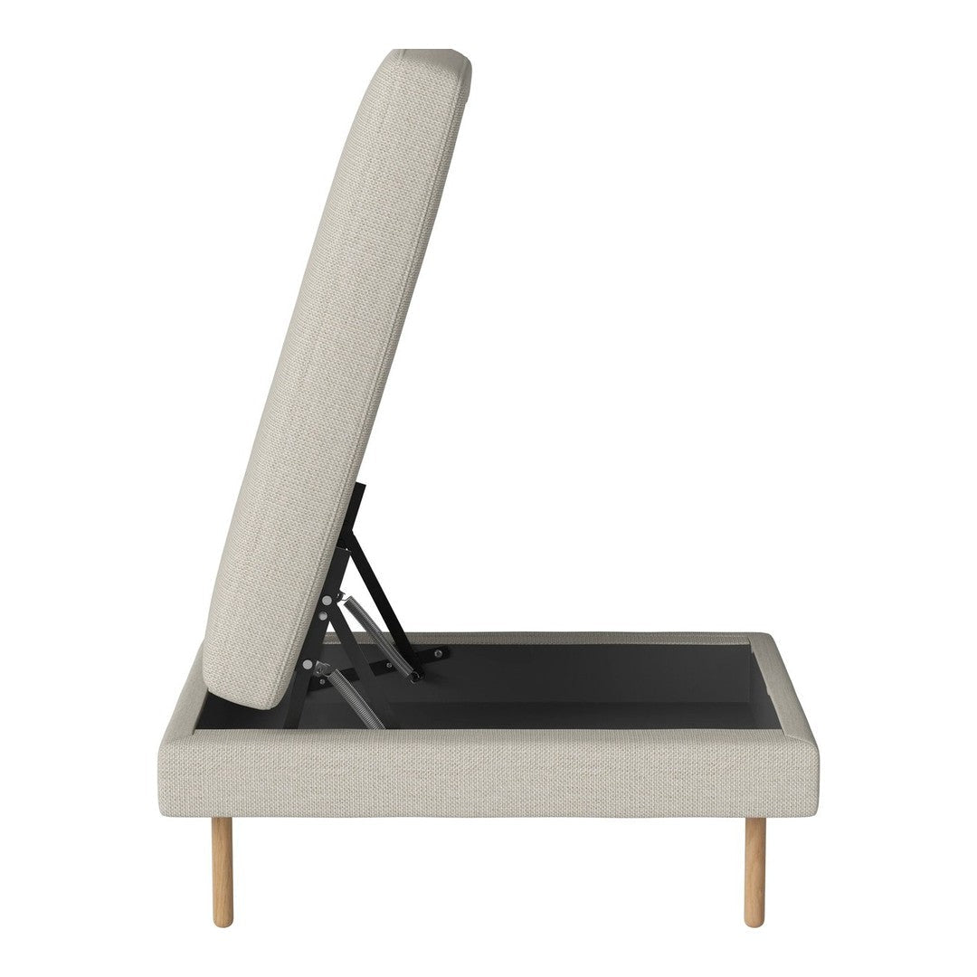 Light beige upholstered daybed with a smooth texture and minimalist design, featuring natural wooden legs.