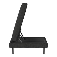 Side view of a black adjustable folding chair with a textured fabric pattern and sleek metal legs.