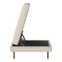 Beige upholstered ottoman with a textured fabric and sleek black detailing. Modern design with metal legs.