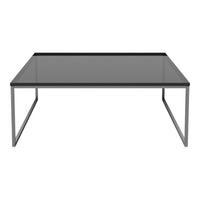 Modern square coffee table with a sleek black glass top and minimalist silver metal frame. Stylish and contemporary design.