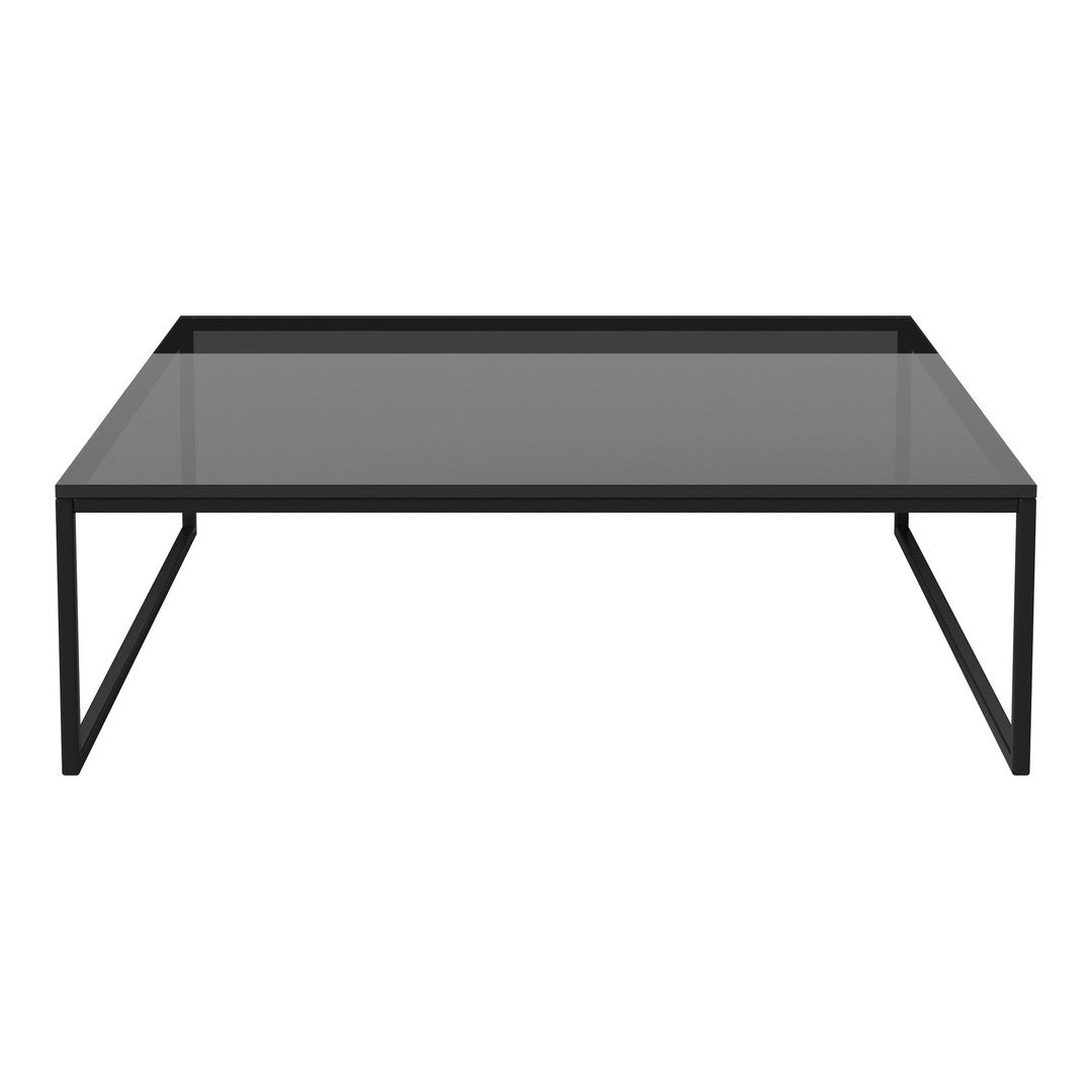 Modern black coffee table with a sleek glass top and minimalist design, perfect for contemporary decor.