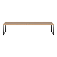 Long wooden tabletop in a natural finish with minimalist black metal legs, creating a sleek and modern look.