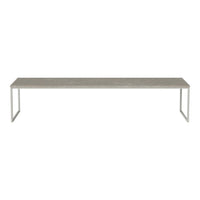 Long, rectangular table with a sleek gray top and modern silver legs, showcasing a minimalist design.