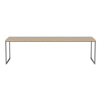 Light wood tabletop with a smooth finish, supported by sleek black metal legs, creating a modern minimalist design.