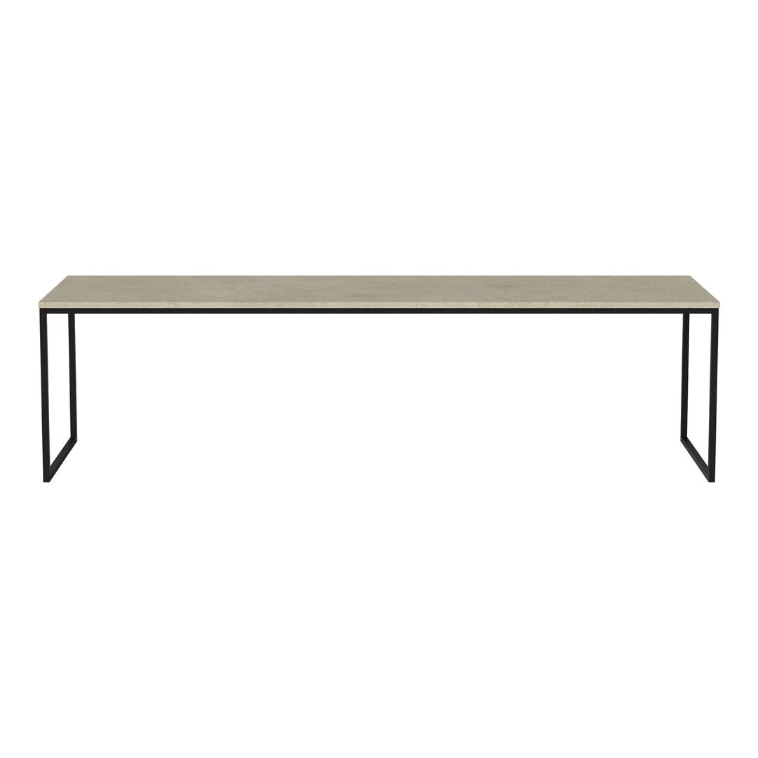 Long beige table with a smooth surface, featuring minimalistic black metal legs, creating a modern contrast.