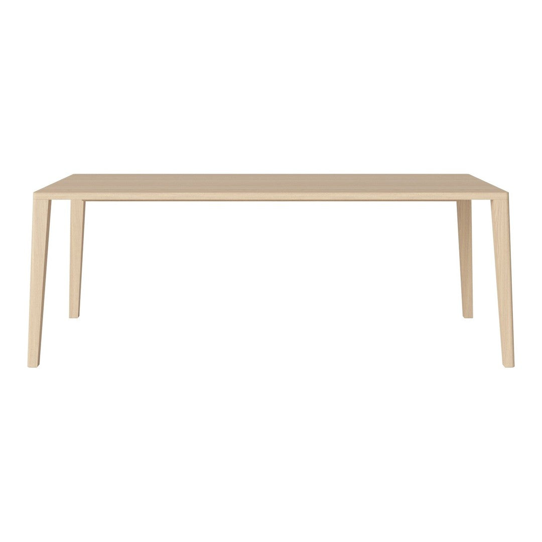 Light-colored, minimalist rectangular table with smooth, solid surface and straight, tapered legs. Perfect for modern decor.