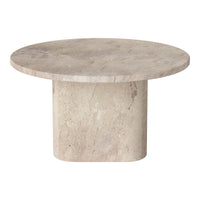 Round beige marble table with a smooth surface and subtle texture, featuring a minimalist design.