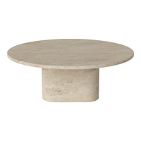 Round beige coffee table with a smooth textured surface and cylindrical base. Modern minimalist design.