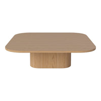 Natural light wood coffee table with a smooth, rounded square top and a cylindrical pedestal base.