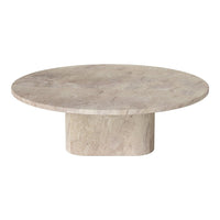Round beige marble coffee table with a smooth surface and cylindrical base, showcasing natural stone patterns.