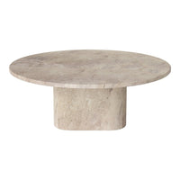 Round beige stone coffee table with a smooth, solid surface and a minimalist cylindrical base.