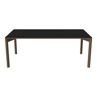 Sleek black tabletop with minimalist brown legs, perfect for modern dining or workspace settings.