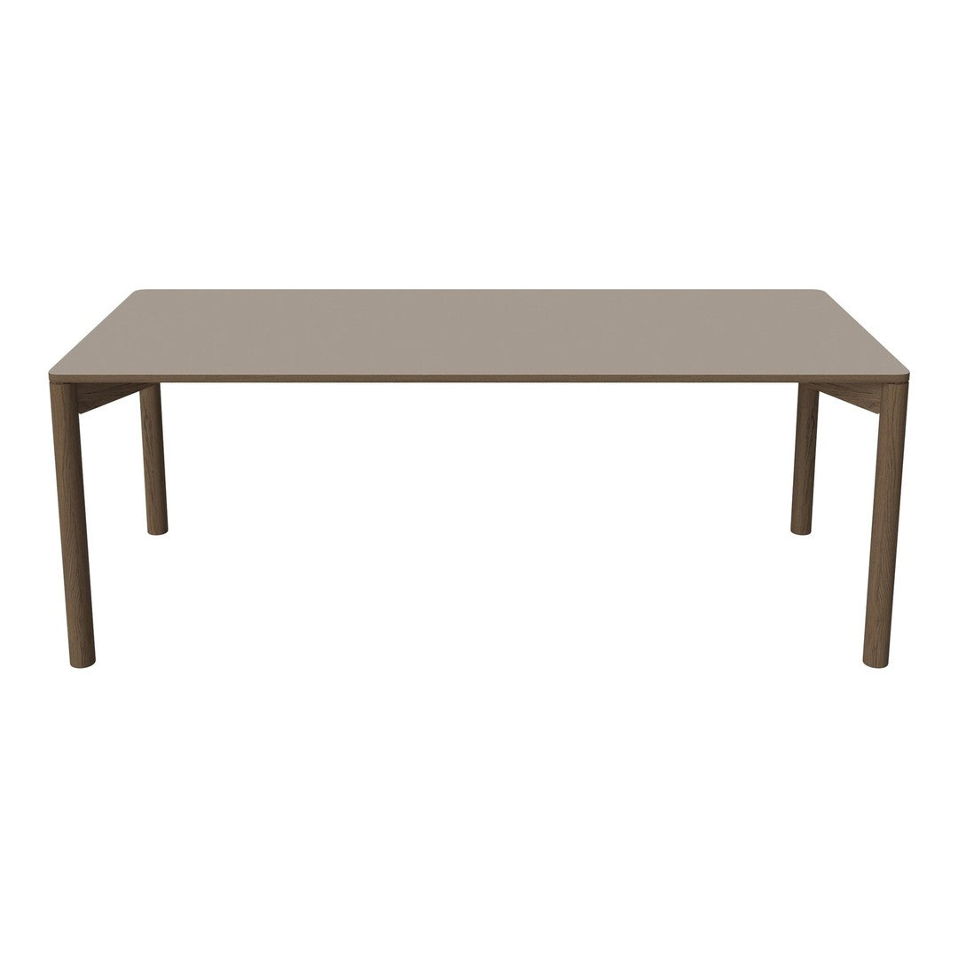 Rectangular table in a soft beige color with a smooth, matte finish and sleek, modern design.