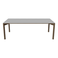 Gray rectangular dining table with sleek, clean lines and wooden legs for a modern aesthetic.