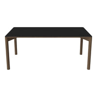 Black tabletop dining table with wooden legs, showcasing a sleek and modern design. Perfect for contemporary spaces.