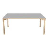 Light wooden table with a smooth gray top, featuring a minimalist design and clean lines. Ideal for modern decor.