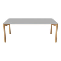 Modern rectangular table with a sleek gray top and natural wood legs. Minimalist design, perfect for contemporary spaces.