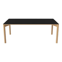 Black tabletop with natural wood legs, featuring a sleek, minimalist design for modern decor.