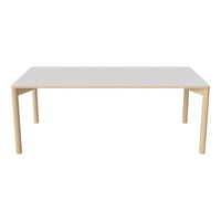 White rectangular table with natural wood legs, showcasing a clean and minimalistic design. Perfect for modern interiors.
