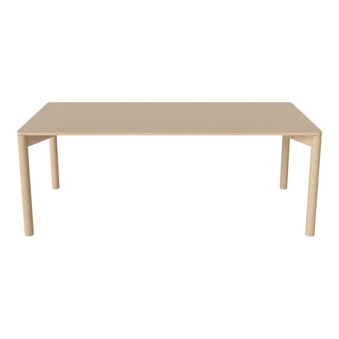 Beige rectangular table with a smooth, matte surface and minimalist straight legs, perfect for modern decor.