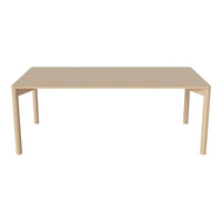 Beige rectangular table with a smooth, matte surface and minimalist straight legs, perfect for modern decor.