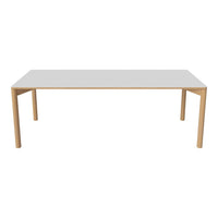 Minimalist white table with natural wood legs, featuring a sleek design and clean lines for a modern aesthetic.