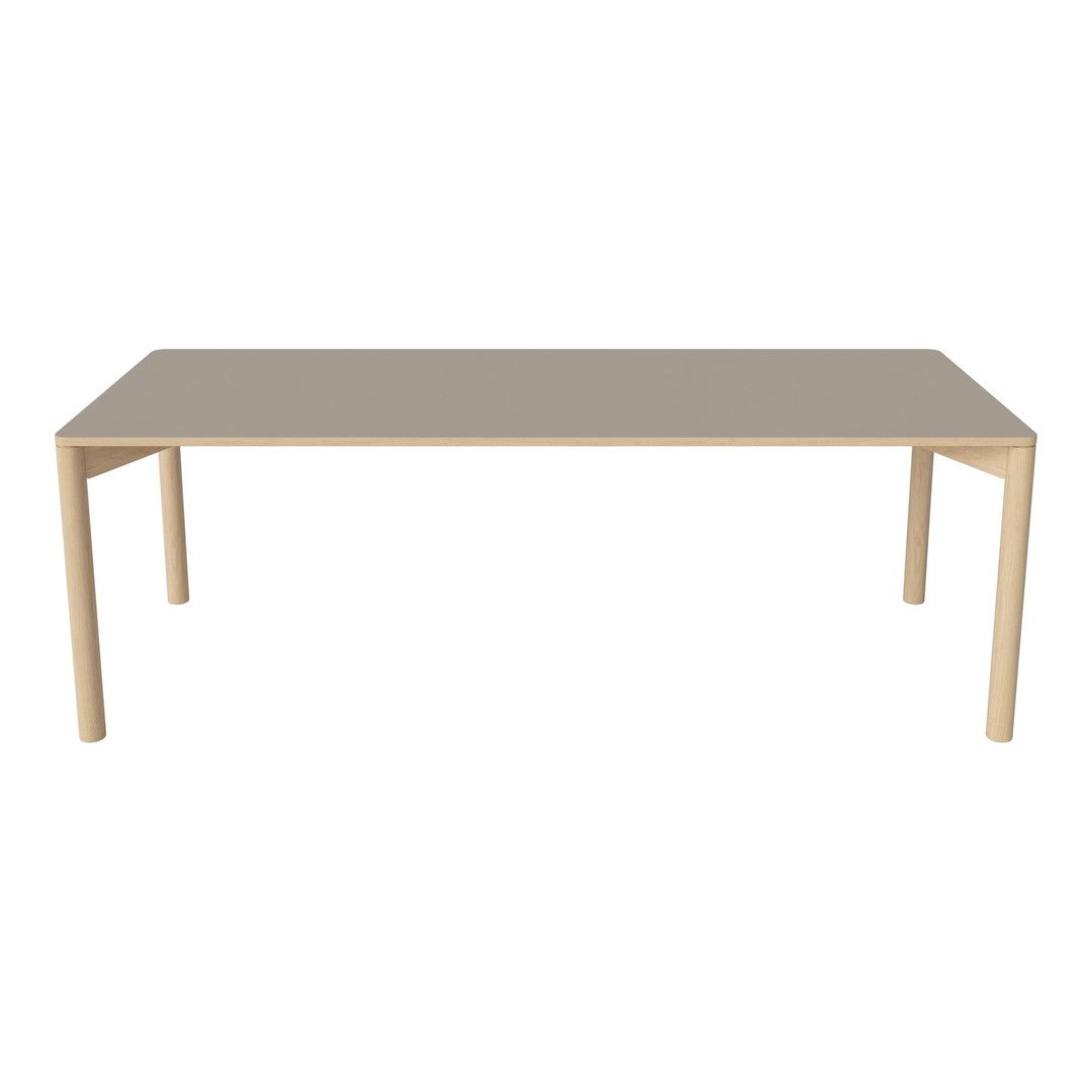 Light beige rectangular table with natural wood legs, featuring a smooth, minimalistic surface design.