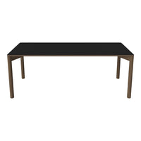 Black rectangular table with sleek, minimalist design and bronze metal legs. Perfect for modern decor.
