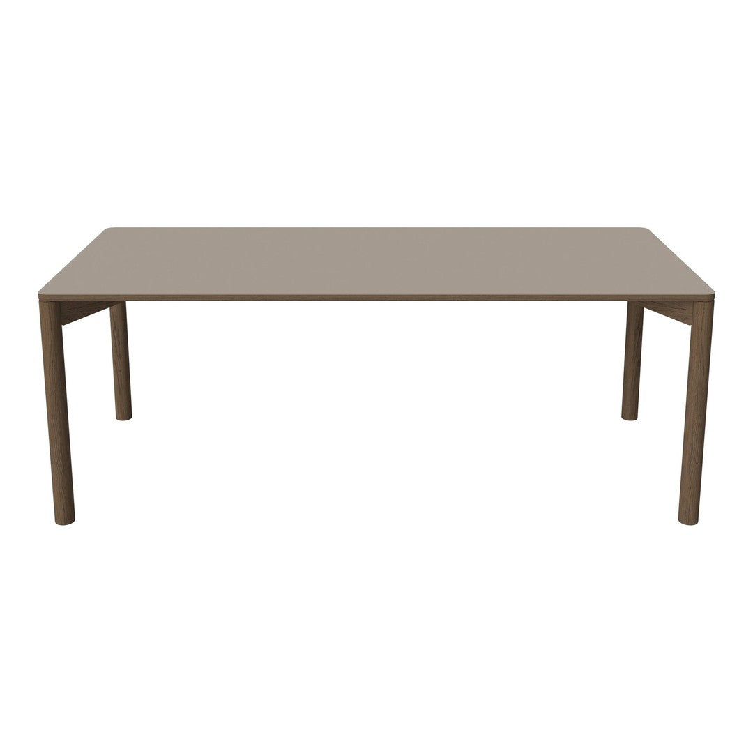 "Rectangular dining table in a solid taupe color with a smooth, modern finish."