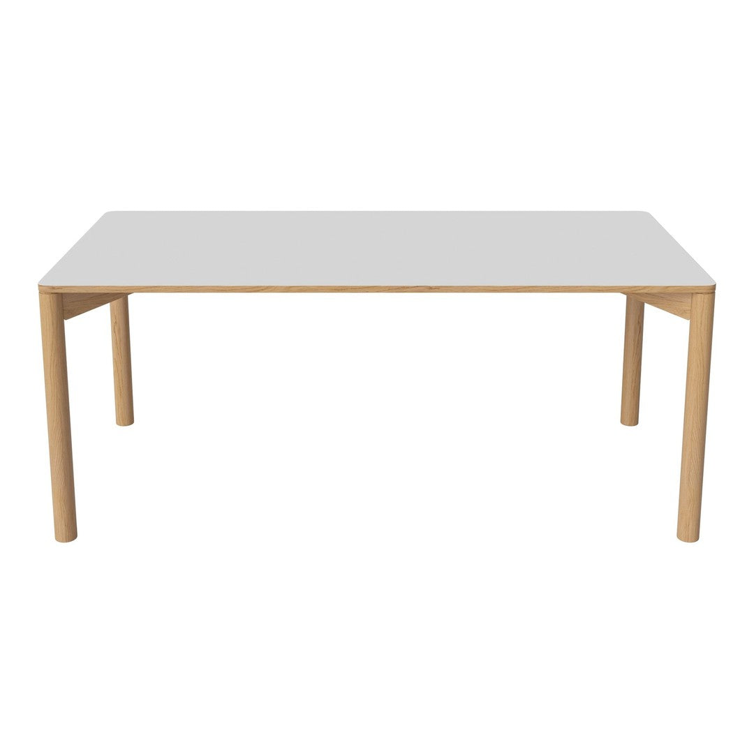 Modern rectangular table featuring a sleek white top and natural wood legs, offering a minimalist and timeless design.