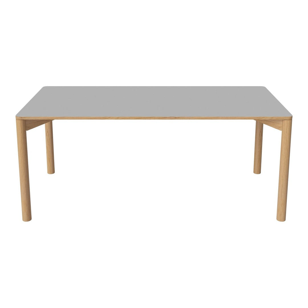 Rectangular dining table with a smooth gray top and natural wood legs, featuring a minimalist design.